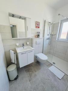 a bathroom with a sink and a toilet and a shower at Rooms by the sea Rab - 18786 in Rab