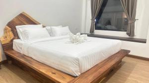 Ένα ή περισσότερα κρεβάτια σε δωμάτιο στο โรงแรมบ้านโอบอ้อม