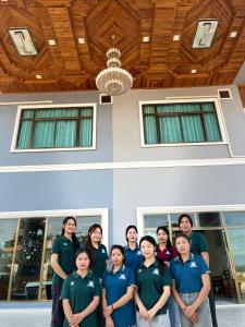 a group of people standing in front of a building at Tulip Hotel in Louang Namtha