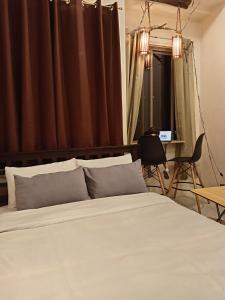 Un dormitorio con una cama, un escritorio y una silla. en Xybel Studio, en Baguio