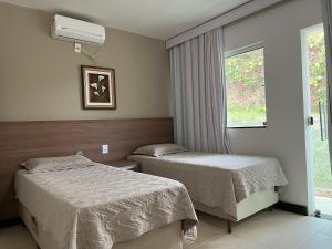 Ένα ή περισσότερα κρεβάτια σε δωμάτιο στο Refúgio Escarpas do Lago Mirante 1702 +26 φωτογραφίες