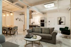 a living room with a couch and a table at Skyway Luxury Stay with Jacuzzi in Bradford +12 photos