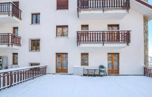 a building with snow on the ground at Casa Maria Grazia in Sauze dʼOulx