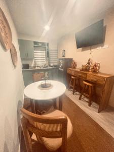 a room with a table and chairs and a kitchen at El descanso in Higuey +8 photos