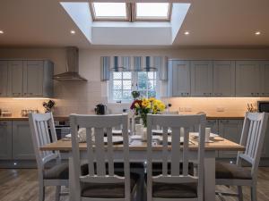 a kitchen with a wooden table with chairs and a dining room at Field View - Ukc2304 in Wainfleet All Saints