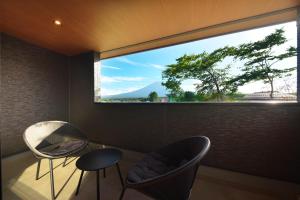 a room with two chairs and a large window at Fuji Gran Villa - TOKI - in Fujiyoshida