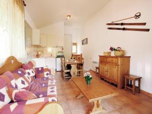 a living room with a couch and a table at Chalet in Villarodin near Lake in La Norma