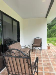 a patio with two chairs and a bench at La casita in General Viejo