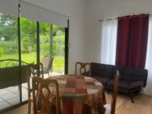 a living room with a table and a couch at La casita in General Viejo