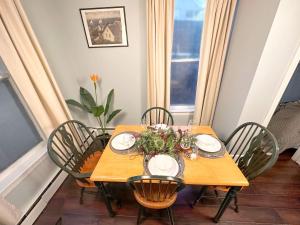 a dining room table with chairs and a table centerpiece at The Salt Soul Suite Cozy Apt 5 in Bridgewater