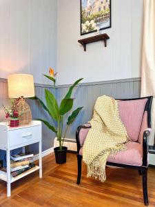 a living room with a chair and a plant at The Salt Soul Suite Cozy Apt 5 in Bridgewater