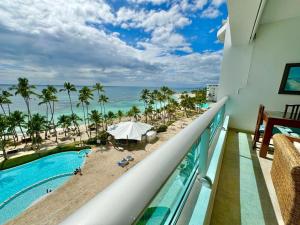 a balcony with a view of a pool and the beach at Apartment in Juan Dolio in Juan Pedro