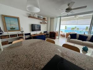 a living room with a table and a couch and a television at Apartment in Juan Dolio in Juan Pedro