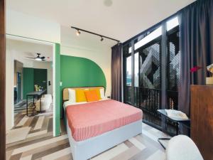 a bedroom with a bed and a balcony at Quay 17 by Cove - Brand new serviced apartments - River Valley, Robertson Quay in Singapore
