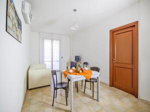 a dining room with a table and chairs and a door at Apartment with garden in Villasimius in Villasimius