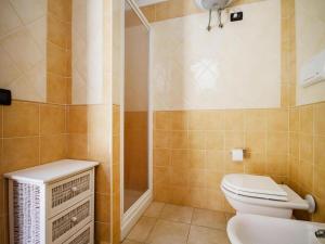 a bathroom with a toilet and a shower and a sink at Apartment with garden in Villasimius in Villasimius +13 photos