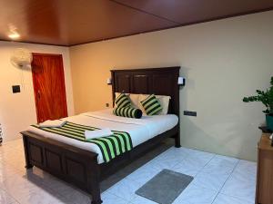 a bedroom with a large bed with striped pillows at Ella Berg Haven in Ella