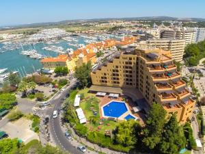 
a large building with a view of the ocean at Dom Pedro Marina in Vilamoura
