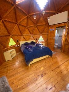 a bedroom with a bed in a wooden room at Villa Rebequita in Villapinzón