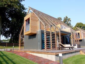 a house under construction with a deck and a bench at Chalet mit Außensauna in Wendorf in Wendorf