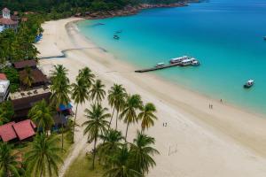 an aerial view of a beach with palm trees and a boat at Redang Divers Resort in Redang Island