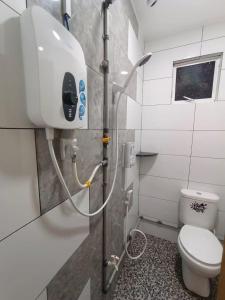 a bathroom with a shower with a toilet in it at Princess Iris Homestay in Penampang +24 photos