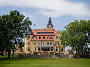 a large yellow building with a tower on top at Reihenhaus Reiterchalet in Wendorf in Wendorf