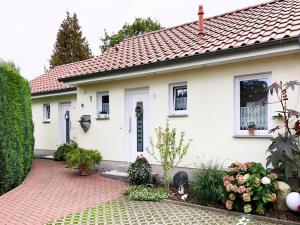 a white house with a red roof at Gemuetliche Doppelhaushälfte in Lubmin in Lubmin