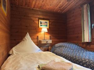 a bedroom with two beds in a wooden room at Charmantes Ferienhaus mit Terrasse in der Südheide in Eschede