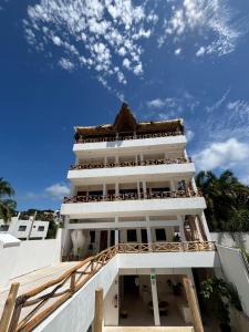 a large white building with a blue sky in the background at Casa Hamaca Nayarit in Chacala