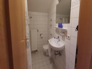 a white bathroom with a sink and a toilet at Stay in Alpine Bayrischzell in Bayrischzell +32 photos