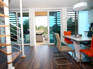 a kitchen with a dining room table and chairs at Chalet mit Außensauna in Wendorf in Wendorf