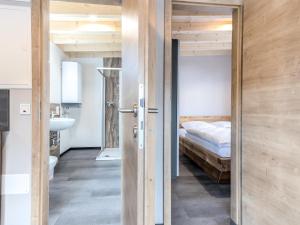 HallschlagHallschlag Lakeside Hideaway的一间带床的卧室和一扇通往浴室的门