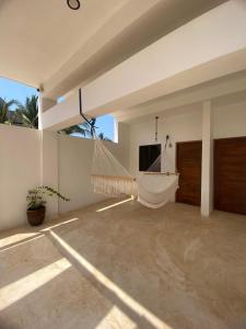 a hammock in the middle of a living room at Casa Hamaca Nayarit in Chacala