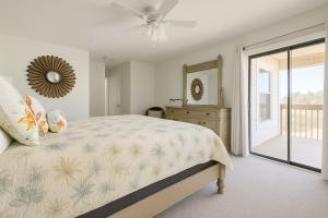 a bedroom with a bed and a ceiling fan at Beachside Bliss - Neptune Nook Unit 2 in Jacksonville Beach
