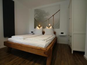 een slaapkamer met een groot bed met witte kussens bij Ferienhaus direkt an der Spree in Frauenberg