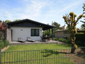 een huis met een patio en een hek bij Ferienhaus direkt an der Spree in Frauenberg