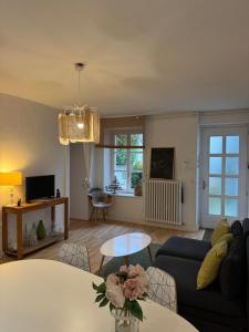 a living room with a couch and a table at Villa Saint-Georges in Vesoul