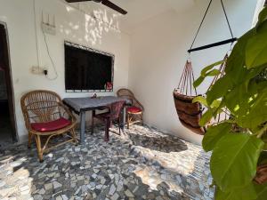 a dining room with a table and two chairs at Palm Breeze Suites in Palolem