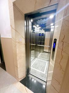 an elevator in a building with a glass door at Serenity Villa Hoi An in Hoi An