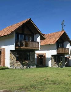 a large white building with a balcony on it at Cabañas Las orquídeas in Huasca de Ocampo