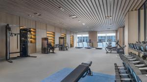 a gym with treadmills and chairs in a building at Holiday Inn Wenzhou Airport by IHG in Wenzhou