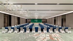 a large conference room with blue tables and white chairs at Holiday Inn Wenzhou Airport by IHG in Wenzhou