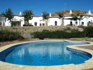 a swimming pool in front of a house at Cave House in Guadix with Private Pool in Bejarín