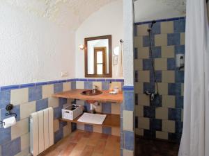 a bathroom with a sink and a mirror at Cave House in Guadix with Private Pool in Bejarín