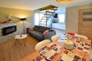 a living room with a table and a couch at Holiday Home near Ko obrzeg with Private Pond in Nieżyn