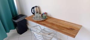 a wooden counter with a tea kettle and a chair at A340 - City center room Papeete in Papeete