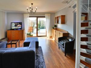 a living room with two couches and a television at Comfortable holiday home with a garden, Kolobrzeg in Luboszyce