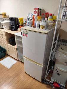 a kitchen with a white refrigerator with food on top of it at 関東最大のスパが身近にあり二部 in Niizo