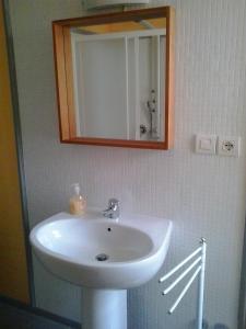 a bathroom with a white sink and a mirror at B&B Casa Carbonara in Cividale del Friuli